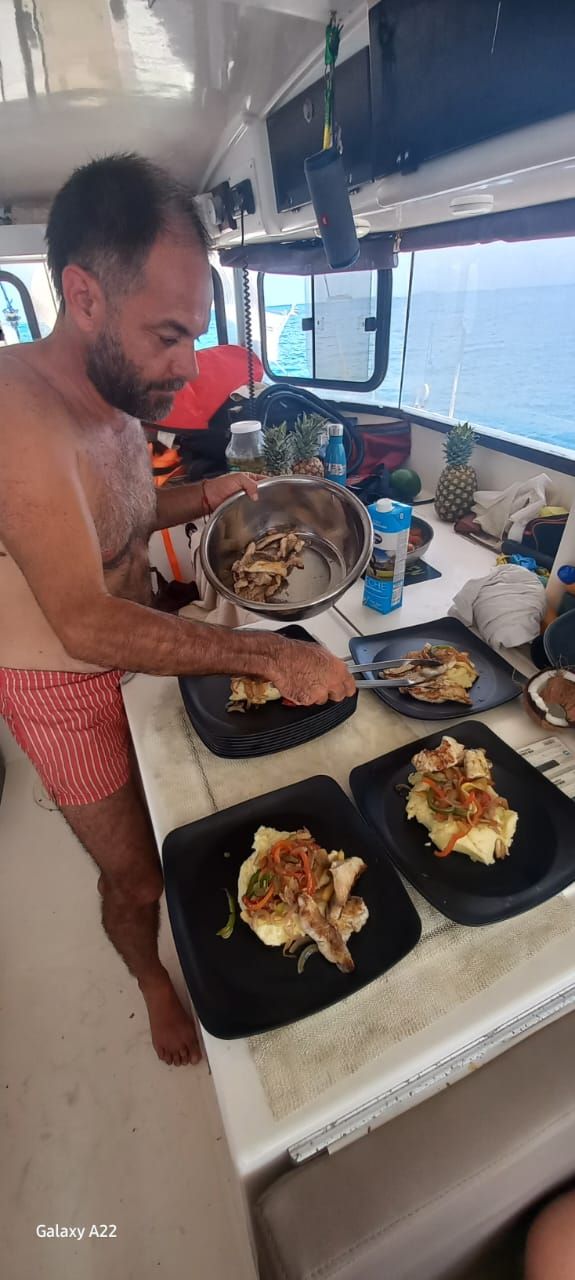 Crew member cooking dinner in the galley