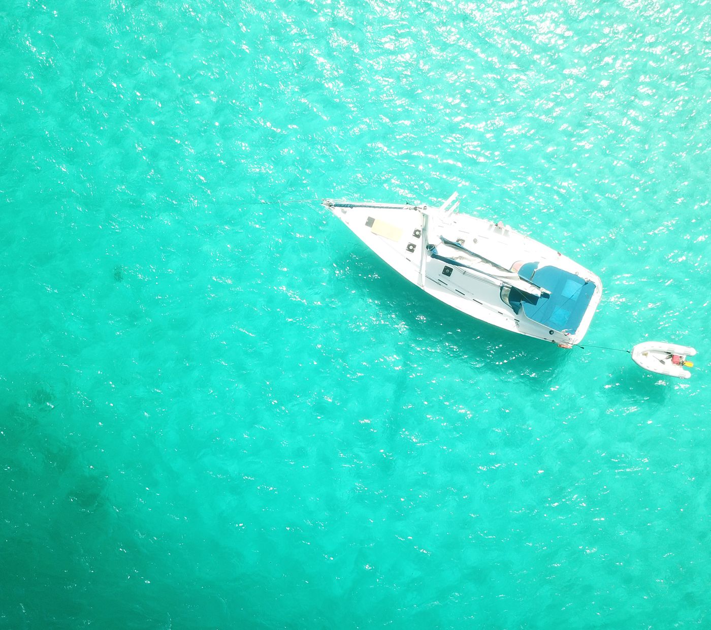 Boat on turquoise water seen from above